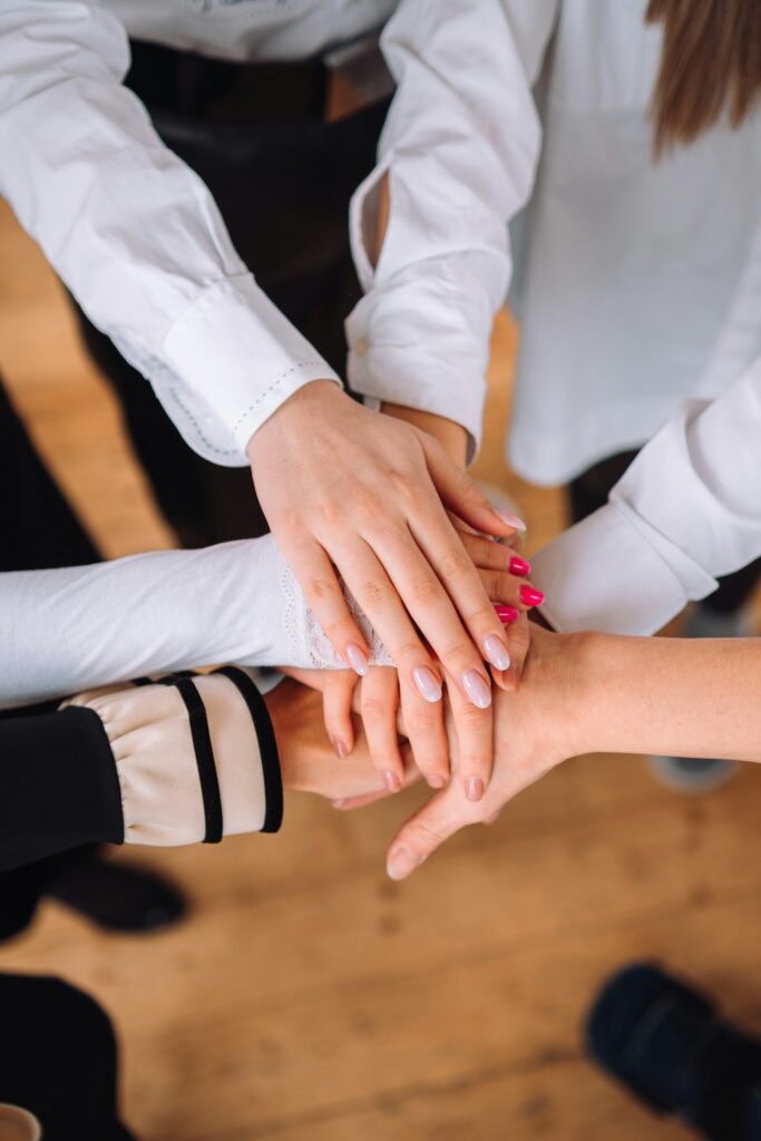 A group of people shaking hands, symbolizing community partnership